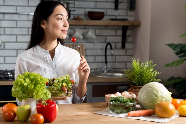 pretty-young-woman-eating-red-cherry-tomato-holding-bowl-mixed-salad_2ea43fcf08194af6ad51e454a492218f_grande